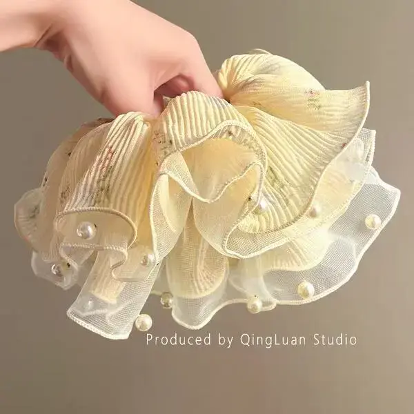 yellow multi ayered pearl hair tie.